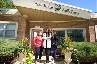 Dr. Susan Thomas and her team outside of their office Park Ridge Smile Center