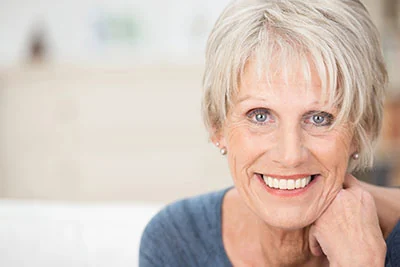 woman smiling after getting dental crowns at Park Ridge Smile Center