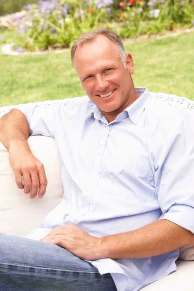 man showing off his smile after getting dental crowns at Park Ridge Smile Center