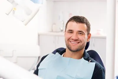 man smiling in the dental chair at Park Ridge Smile Center