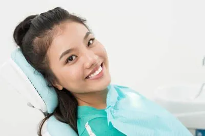 woman smiling during her restorative appointment at Park Ridge Smile Center