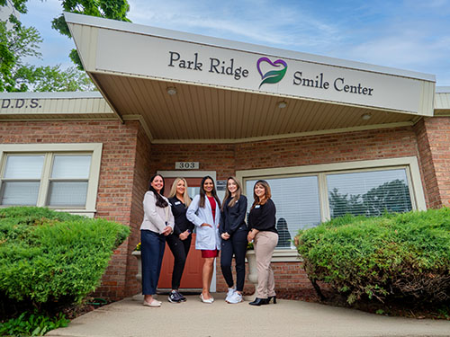 Dr. Susan Thomas and her team outside of their office Park Ridge Smile Center