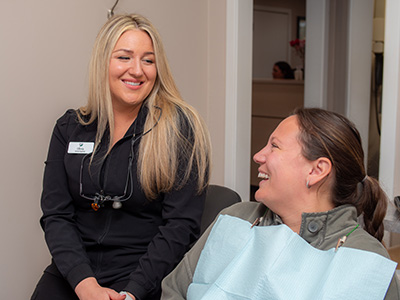 woman smiling during her restorative appointment at Park Ridge Smile Center